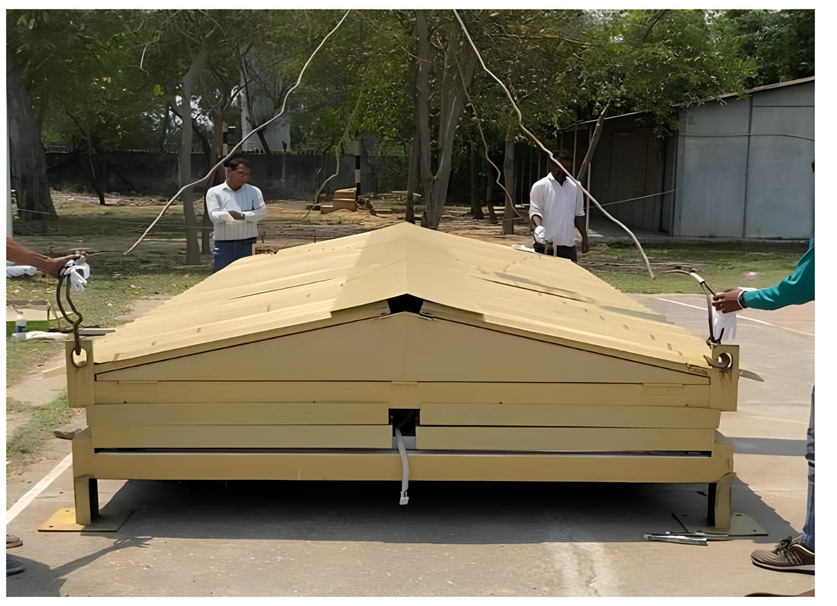 Collapsible modular container shelter in folded position ready for transport and installation
